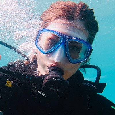 woman scuba diving with a blue mask