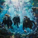 Women diving in clear water