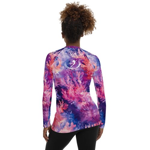 The back of Whispers of the Reef women's rash guard, on a model.