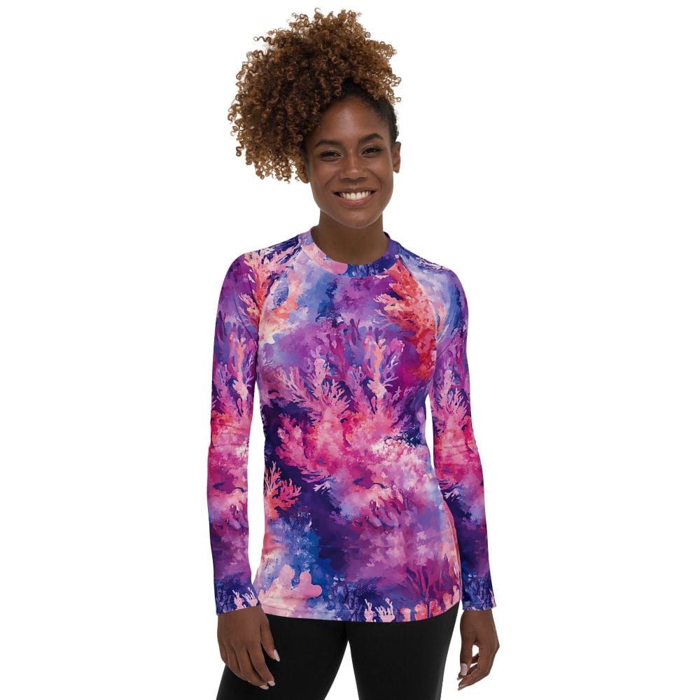 Smiling women modeling a coral reef print rash guard.