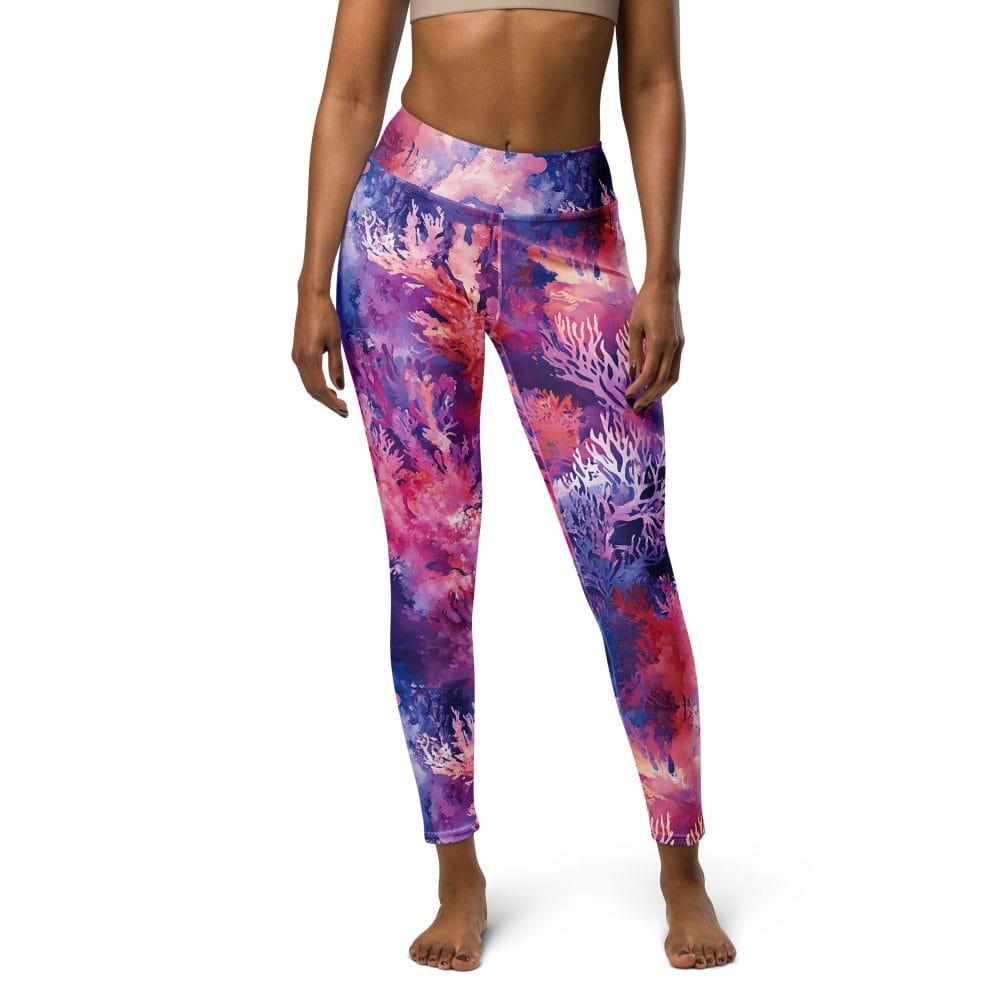 Coral reef print on women's swim leggings, worn by a model facing front.